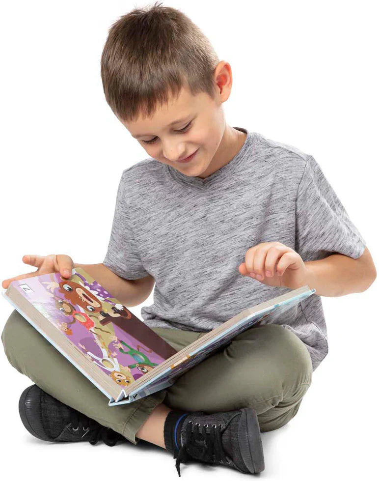 Boy reading a large book.