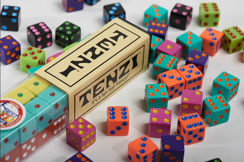 Bunch of dice on a table with game box.