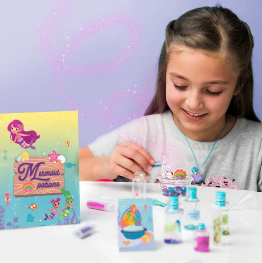 Girl playing with mermaid crafts.