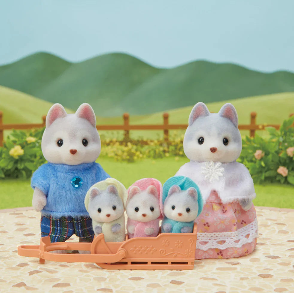 Miniature doll cat family with kids on a sled.