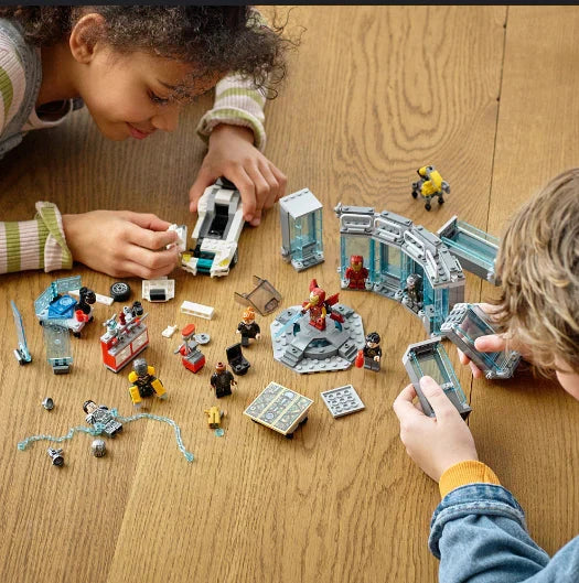 Two kids playing with interlocking block pieces.