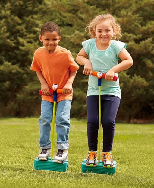 Boy and girl jumping on a pogo jumper.